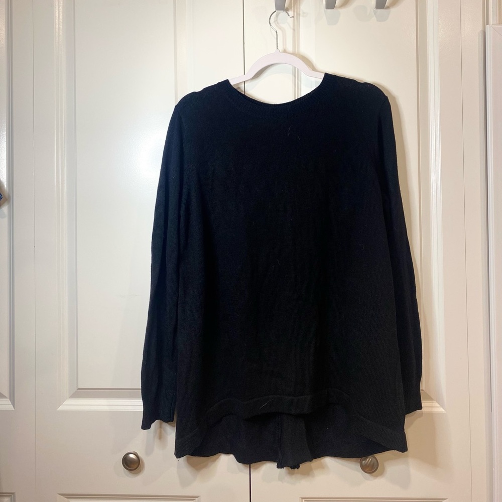 Black medium large sweater has a zipper back to make it a little bit bigger